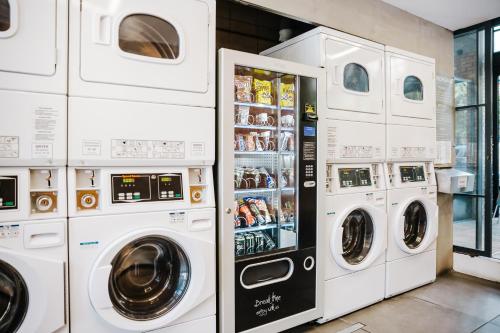 a group of washers and dryers in a store at Athens Studios in Athens