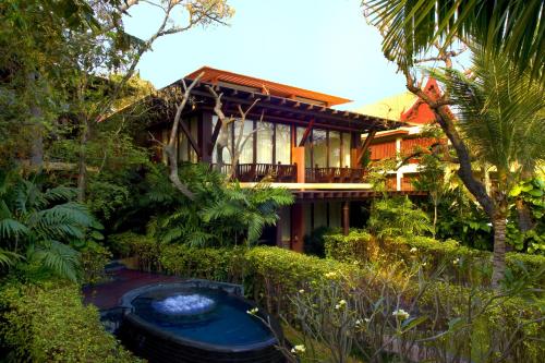 a house with a pond in the middle of a garden at The BARAI by Hyatt in Hua Hin