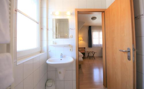 a bathroom with a sink and a mirror at Gasthof Lamm in Beilstein