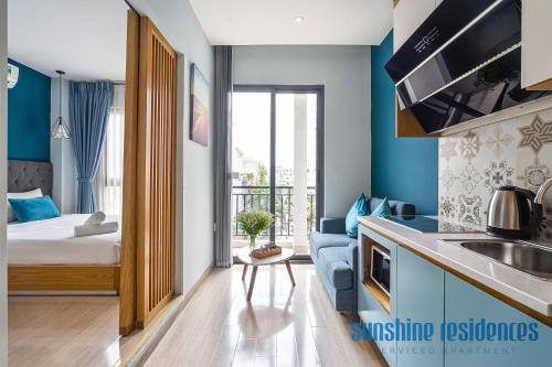 a room with a bed and a kitchen with a sink at The Art - Sunshine Apartment in Ho Chi Minh City
