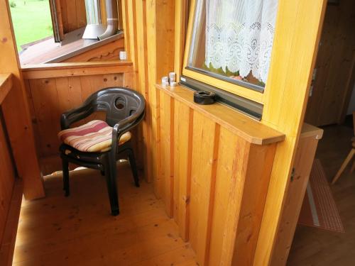 a chair sitting in a room with a window at Ferienwohnungen Marchanger in Niederau