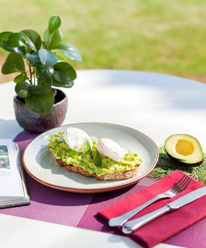 a plate of food with eggs on a table at The BARAI by Hyatt in Hua Hin
