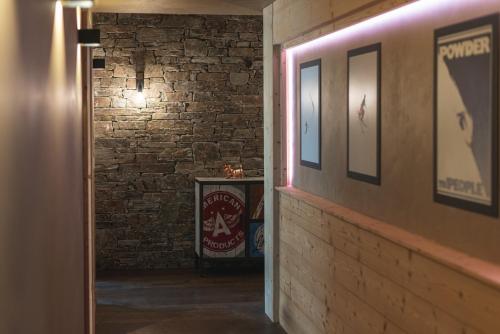 a hallway with a brick wall and a pink light at Joe's Place - luxury lifestyle apartment in Zermatt