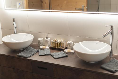 two sinks on a counter in a bathroom at Joe's Place - luxury lifestyle apartment in Zermatt