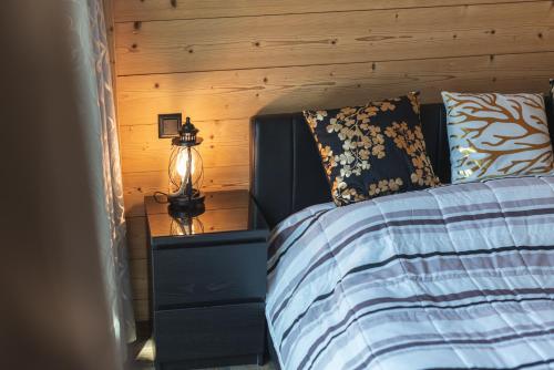 a bedroom with a bed with a wooden wall at Joe's Place - luxury lifestyle apartment in Zermatt