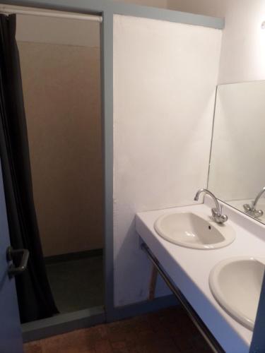 a bathroom with a sink and a shower at Auberge de Jeunesse HI Cadouin in Le Buisson de Cadouin
