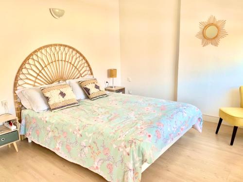 a bedroom with a large bed with a wooden headboard at Central Narbonne with rooftop terrace in Narbonne