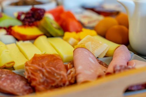 a tray of different types of fruits and vegetables at Central Fira Suites in Fira