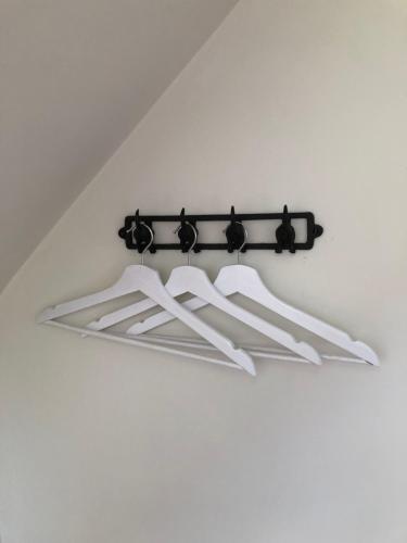 a black and white light fixture on a white wall at The Old School, Idbury, OX7 6RU in Chipping Norton
