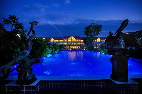 a resort with a swimming pool at night at MAYFAIR Tea Resort in Siliguri