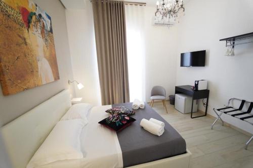 a bedroom with a bed and a living room at Il Diamante nei Sassi Rooms in Matera