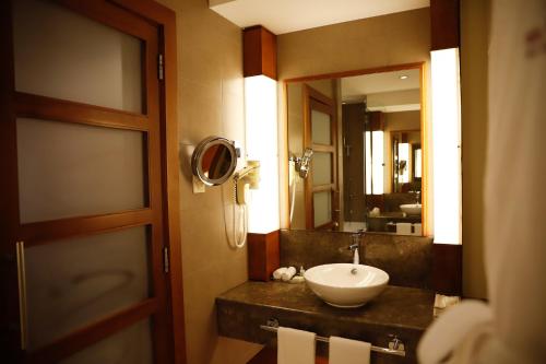 a bathroom with a sink and a mirror at Crowne Plaza Sohar by IHG in Sohar