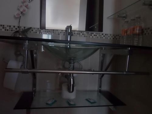 a glass sink in a bathroom with a mirror at Hotel Raldos Inn in Salamanca