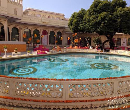 a large pool in the middle of a building at Shiv Niwas Palace by HRH Group of Hotels in Udaipur