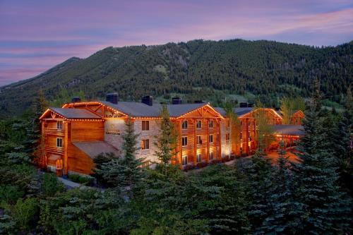a large building in the middle of a forest at The Lodge at Jackson Hole in Jackson