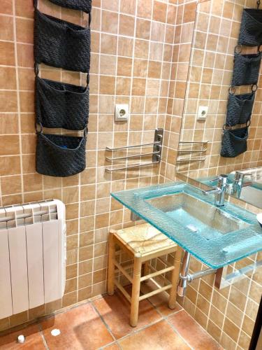 a bathroom with a blue sink and towels at PROBER-CHAMOIX 68 in Encamp