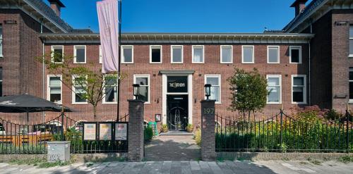 a brick building with a gate in front of it at The Anthony Hotel in Utrecht