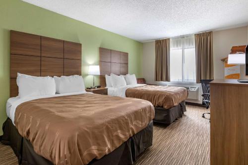 a hotel room with two beds and a desk at Quality Inn in Creston