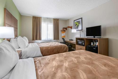 a hotel room with two beds and a flat screen tv at Quality Inn in Creston