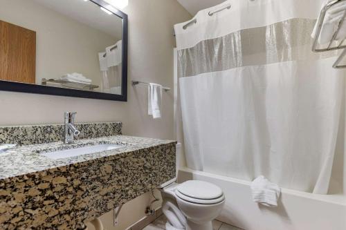 a bathroom with a toilet and a sink and a shower at Quality Inn in Creston