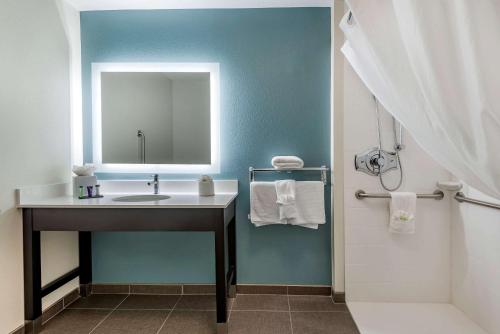 a bathroom with a sink and a mirror at Sleep Inn Durango in Durango