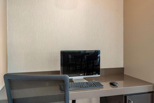 a desk with a computer monitor and a keyboard and mouse at Sleep Inn Durango in Durango