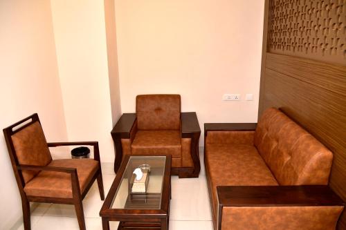 a waiting room with a couch and a chair at Aloka Stay Inn in Vellore