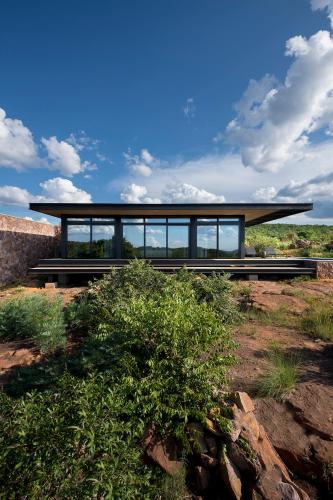 a house on a hill with a large building at 57 Waterberg in Welgevonden Game Reserve