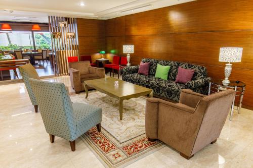 a lobby with a couch and chairs and a table at Hotel HD Palace in Taipei