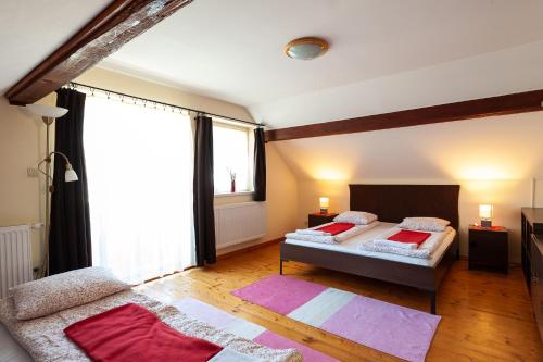 a bedroom with two beds and a large window at Haus Alpenblick Mölltal in Flattach