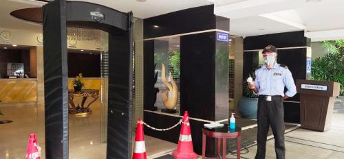 a police officer standing in front of a store at Best Western Ashoka in Hyderabad