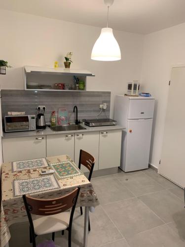 a kitchen with a table and a kitchen with a stove at PREMIUM COMFORT PRIVATE in Beer Sheva