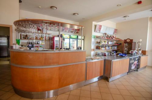 a restaurant with a counter and a bar in a room at Pasienis in Pasvaliečiai