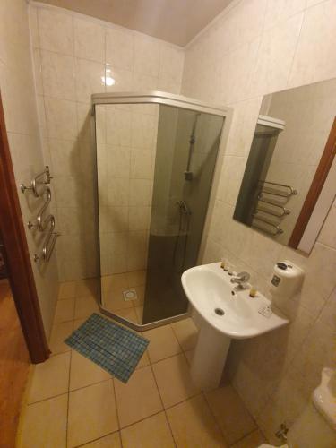 a bathroom with a shower and a sink at Pasienis in Pasvaliečiai