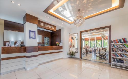 a store lobby with a reception and a window at Oscar Hotel in Laganas
