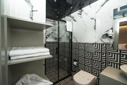 a bathroom with a shower and a toilet at Basel Hotel in Antalya