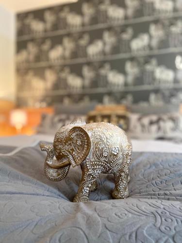 a small gold elephant figurine sitting on a blanket at Parseierblick in Sankt Anton am Arlberg