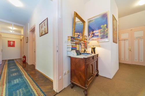 a hallway with a table with a lamp and books at B&B Sesame Inn in Dubrovnik
