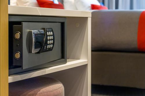 a tv with a remote control inside of it at Holiday Inn Express - Bodmin - Victoria Junction by IHG in Bodmin