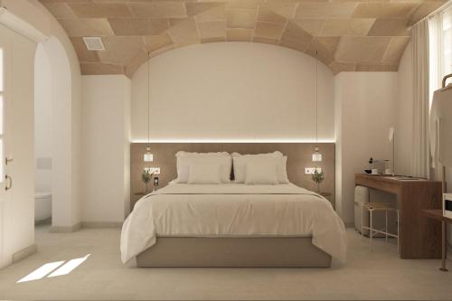 een witte slaapkamer met een groot bed met witte kussens bij LLONGA'S 7th in Ciutadella