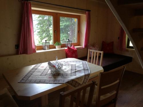 a table and chairs in a room with a window at Tanterhütte by Tanterhof in Schwendau
