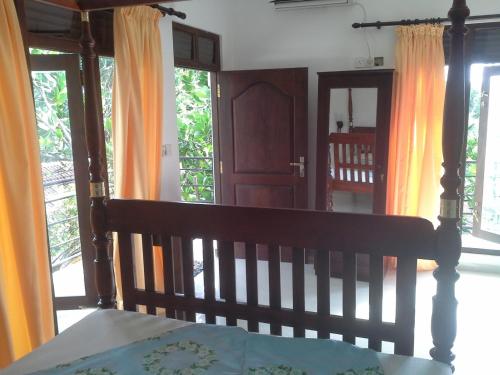 a bedroom with a bed with an open door at Dreamvillage in Dodanduwa