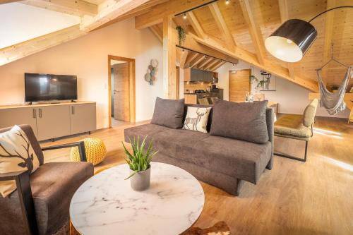 a living room with a couch and a table at Seelos - Alpine Easy Flats in Mieming