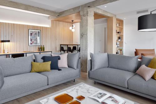 a living room with two couches and a table at Jai Alai 54 by FeelFree Rentals in Donostia-San Sebastián