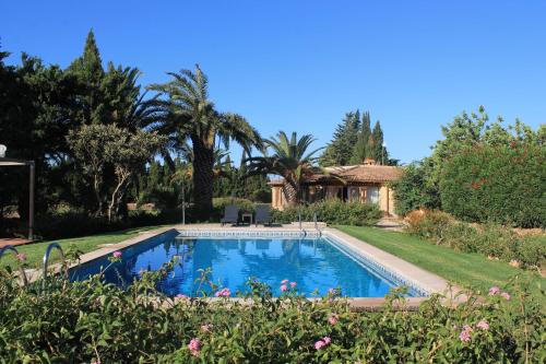 a swimming pool in the yard of a house at Finca Verde in Llucmajor
