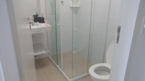 a bathroom with a shower and a toilet and a sink at Sorrento Suítes Maragogi a 3 min da Orla in Maragogi
