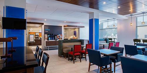 a kitchen with a dining room table and chairs at Holiday Inn Express & Suites - Brandon, an IHG Hotel in Brandon