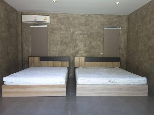 Postel nebo postele na pokoji v ubytování Baan Nuin Morn Norn Suan