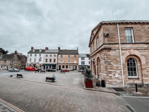 an empty street in a town with buildings at The Blenheim Buttery in Woodstock