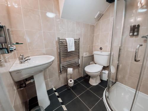 a bathroom with a sink and a toilet and a shower at The Blenheim Buttery in Woodstock